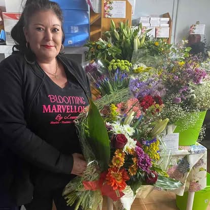 Lorena, florist at Blooming Marvellous, in her shop with a bouquet